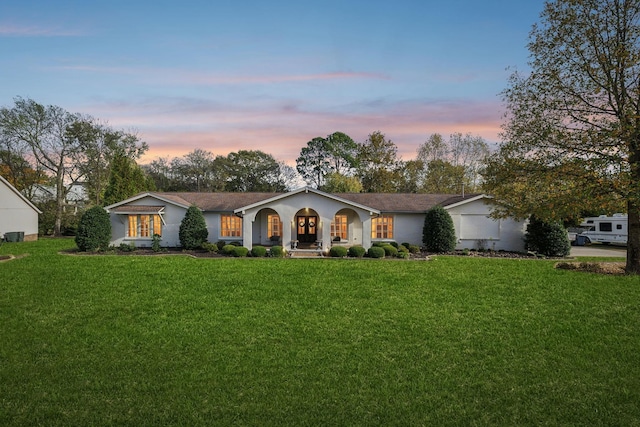 ranch-style home featuring a lawn