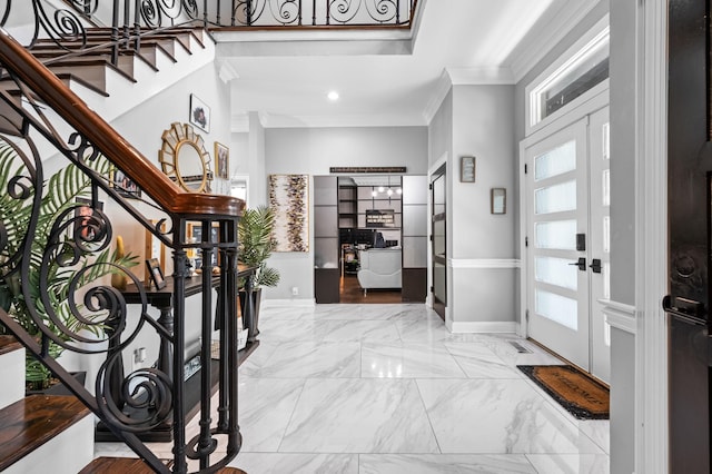 entrance foyer featuring plenty of natural light and ornamental molding