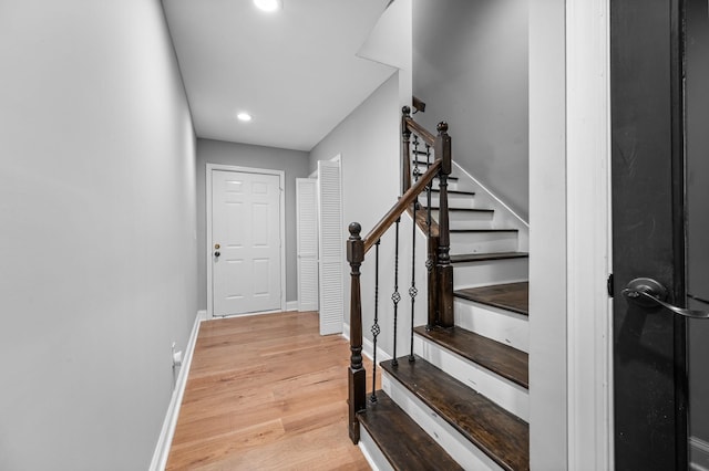 staircase with hardwood / wood-style flooring