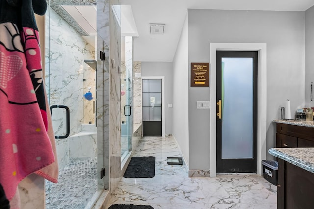 bathroom featuring vanity and a shower with door