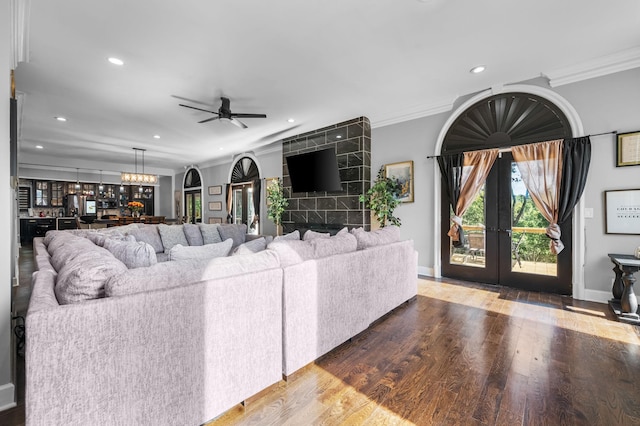 living room with ceiling fan, french doors, crown molding, and hardwood / wood-style flooring