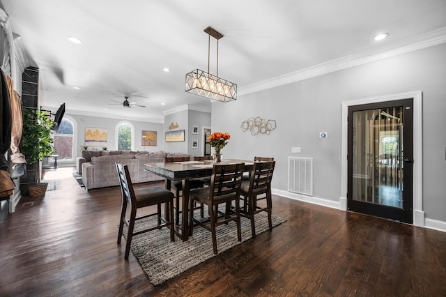 dining room featuring ceiling fan, dark hardwood / wood-style flooring, and crown molding