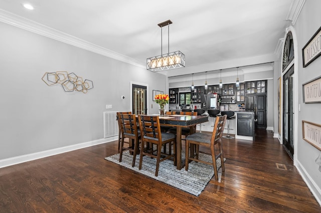 dining area with dark hardwood / wood-style floors and ornamental molding