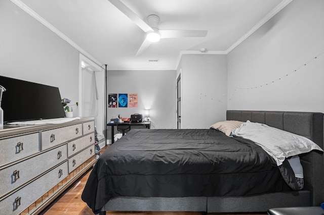 bedroom with ceiling fan, hardwood / wood-style floors, and crown molding