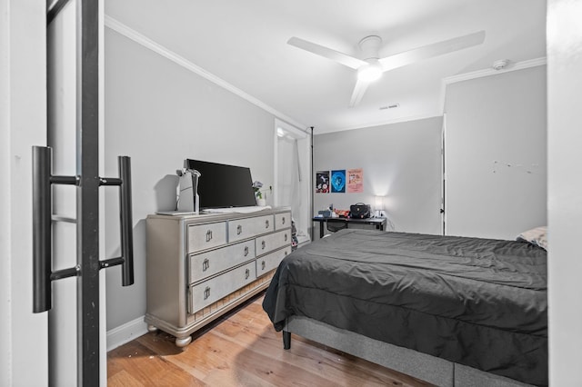 bedroom featuring ceiling fan, wood-type flooring, and crown molding