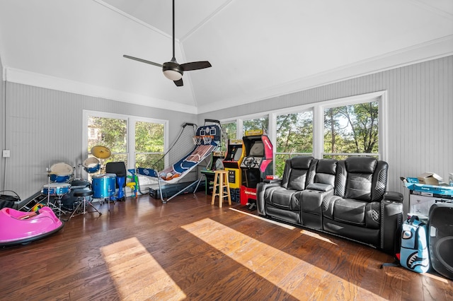 playroom with ceiling fan, crown molding, dark wood-type flooring, and vaulted ceiling