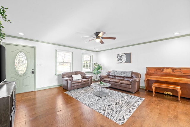 living room featuring ceiling fan, light hardwood / wood-style floors, and ornamental molding