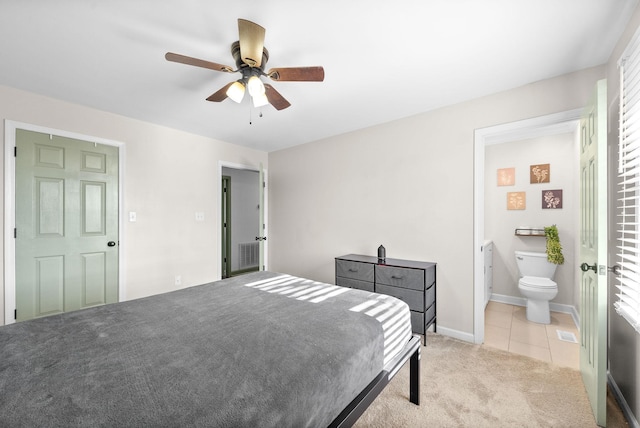 tiled bedroom featuring multiple windows, connected bathroom, and ceiling fan