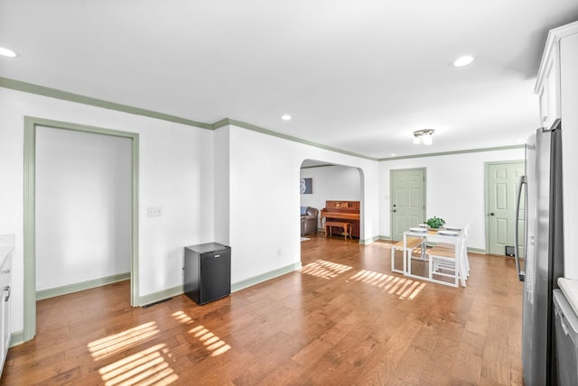 interior space featuring hardwood / wood-style floors and ornamental molding