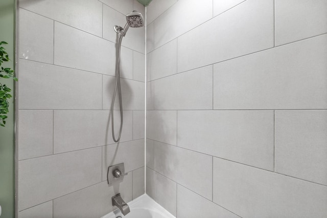 room details with tiled shower / bath combo