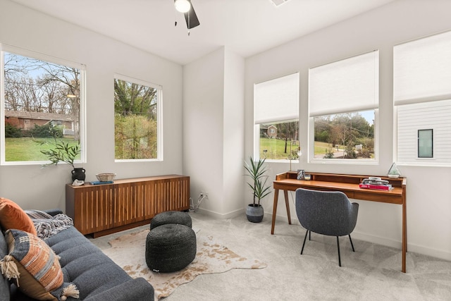 carpeted home office featuring ceiling fan and radiator heating unit