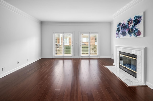 unfurnished living room with a premium fireplace, crown molding, and dark hardwood / wood-style floors