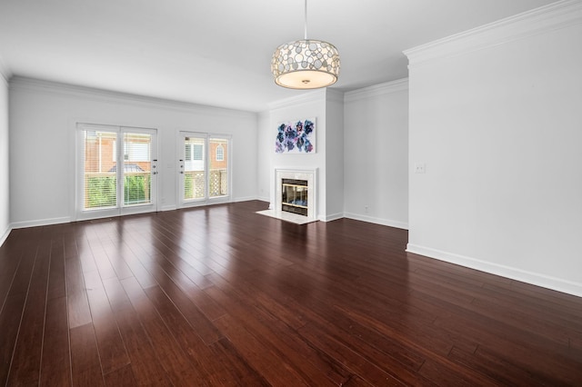 unfurnished living room featuring a fireplace, dark wood-type flooring, and ornamental molding