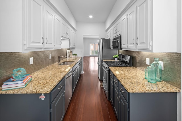 kitchen featuring tasteful backsplash, stainless steel appliances, sink, dark hardwood / wood-style floors, and white cabinetry