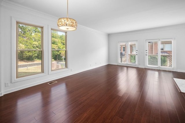 empty room with crown molding and dark wood-type flooring