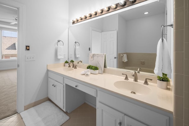 bathroom featuring vanity, tile patterned floors, ceiling fan, and a bathing tub