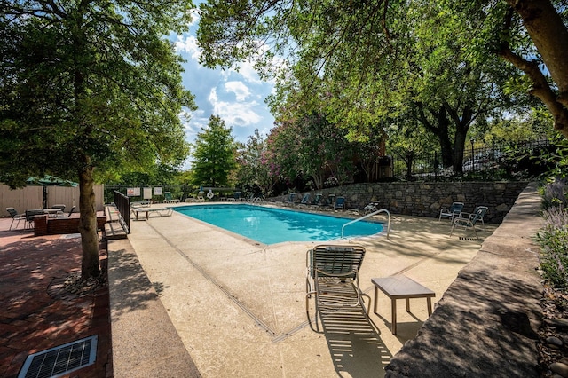 view of swimming pool with a patio