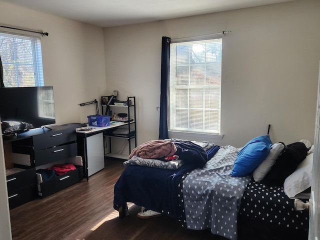 bedroom with dark hardwood / wood-style flooring