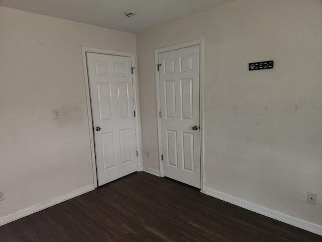 unfurnished room with dark hardwood / wood-style floors