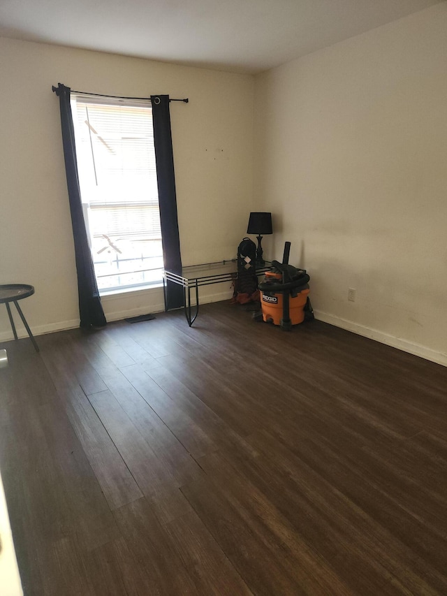 spare room with dark hardwood / wood-style floors