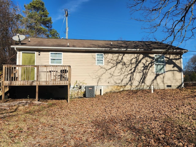 rear view of house with central AC and a deck