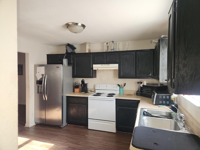 kitchen featuring white electric range oven, stainless steel fridge, dark hardwood / wood-style floors, and sink