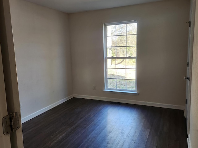 unfurnished room with dark hardwood / wood-style floors