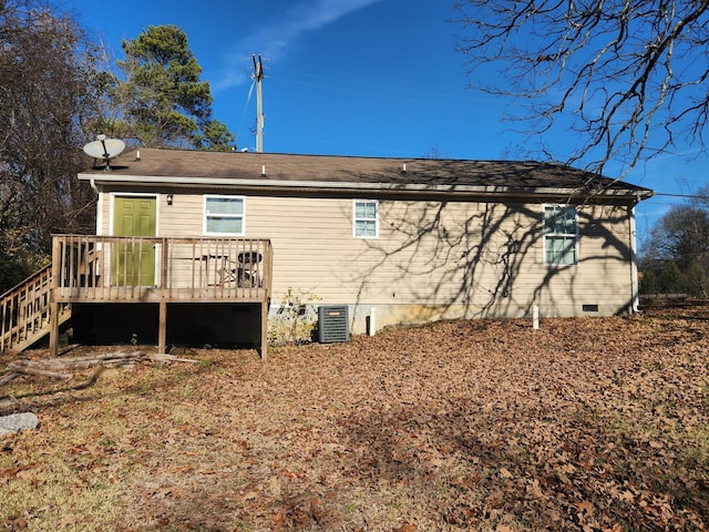 back of property with a wooden deck and central AC