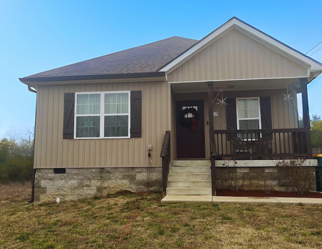 view of front of house featuring covered porch and a front yard