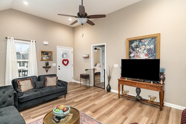 living room featuring ceiling fan, high vaulted ceiling, and light hardwood / wood-style floors