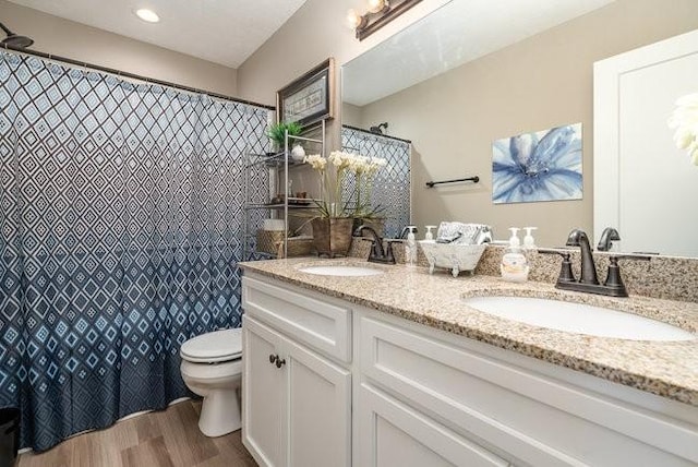 bathroom featuring vanity, hardwood / wood-style floors, and toilet