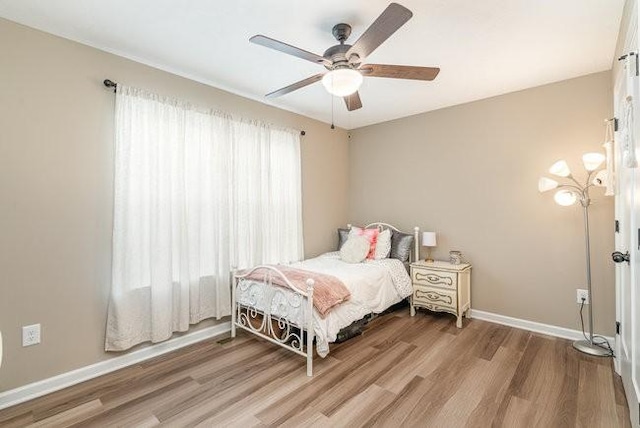 bedroom with hardwood / wood-style flooring and ceiling fan