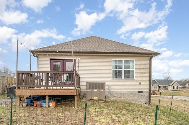 rear view of property with a deck, a lawn, central AC unit, and french doors