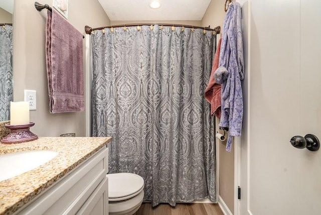 bathroom featuring vanity, hardwood / wood-style floors, toilet, and a shower with shower curtain