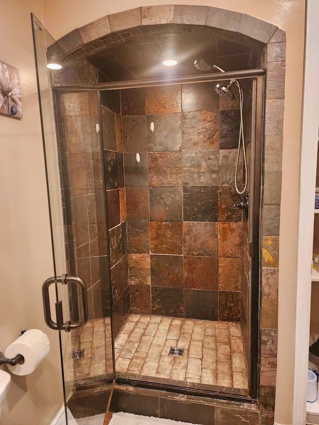 bathroom featuring a shower with door