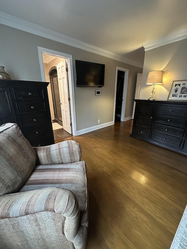 living area with dark hardwood / wood-style floors and ornamental molding