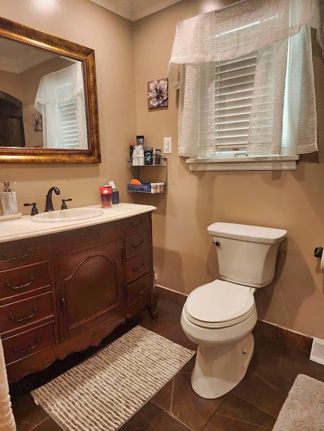 bathroom featuring crown molding, vanity, and toilet