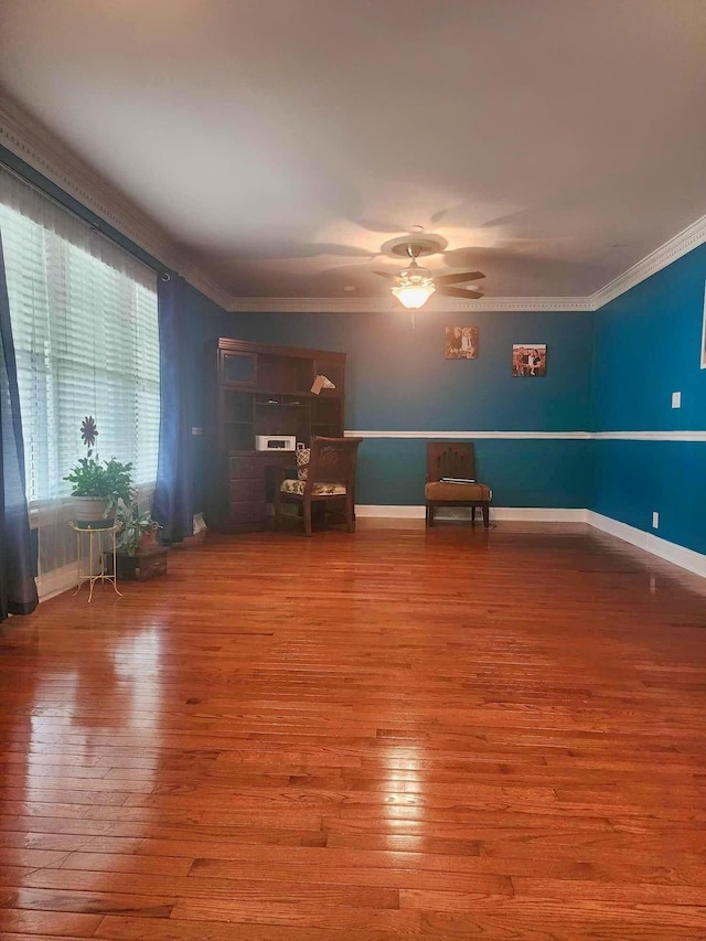 unfurnished room featuring ceiling fan, wood-type flooring, and ornamental molding