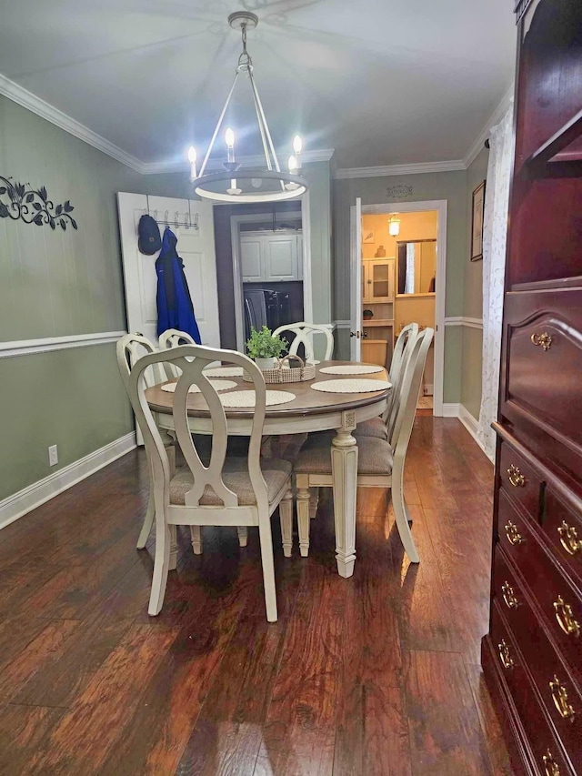 dining area with crown molding, dark wood-type flooring, and a notable chandelier