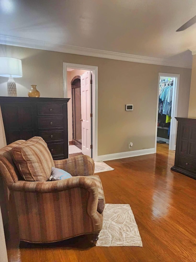 living room featuring hardwood / wood-style flooring and crown molding