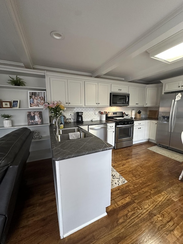 kitchen featuring kitchen peninsula, sink, appliances with stainless steel finishes, beamed ceiling, and white cabinetry