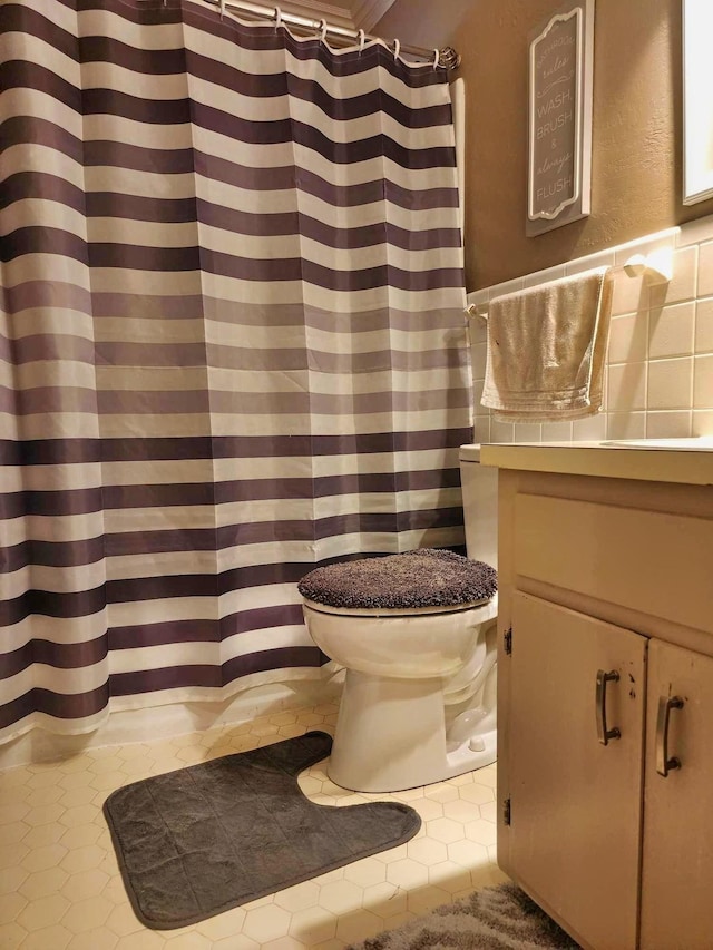 bathroom with toilet, tile patterned floors, walk in shower, and crown molding