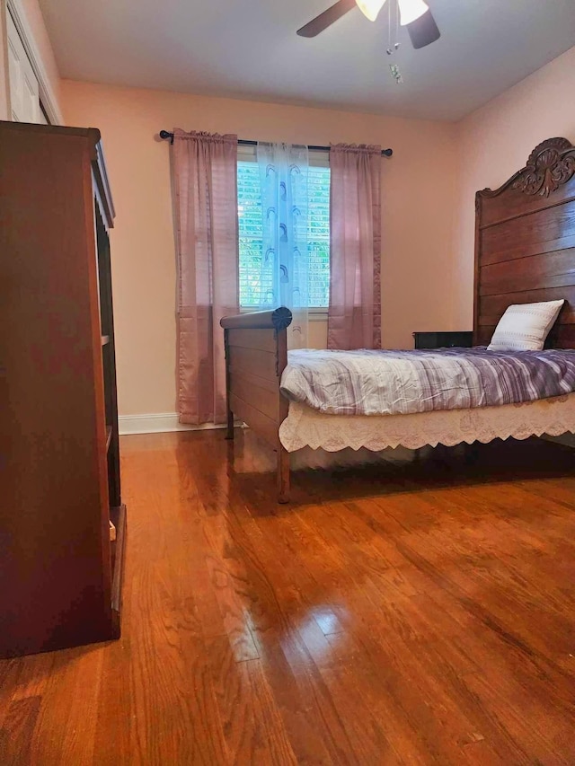 bedroom featuring hardwood / wood-style floors and ceiling fan