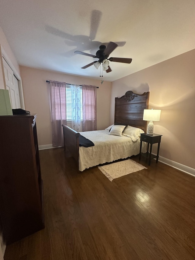 bedroom with ceiling fan, dark hardwood / wood-style floors, and a closet