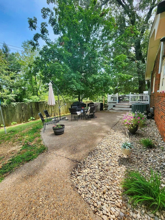 view of yard featuring central AC unit and a patio