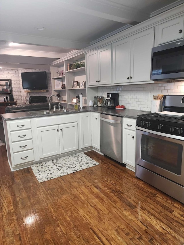 kitchen featuring beam ceiling, sink, tasteful backsplash, dark hardwood / wood-style floors, and appliances with stainless steel finishes