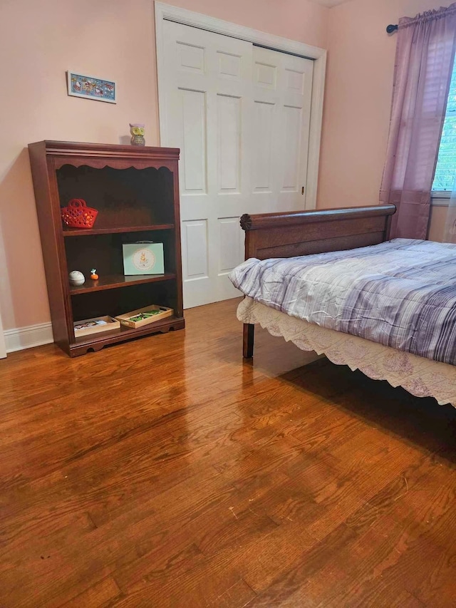 bedroom with hardwood / wood-style floors and a closet