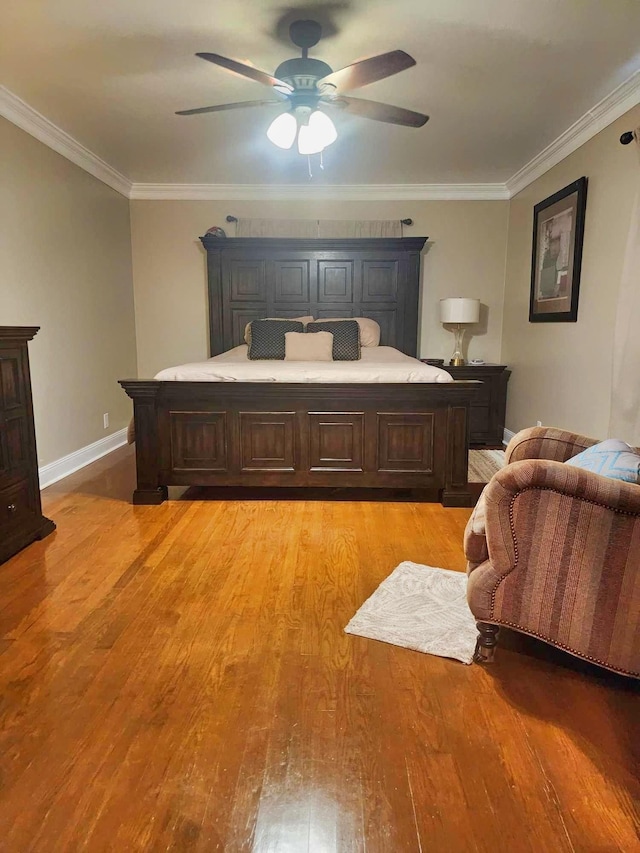 bedroom with light wood-type flooring, ceiling fan, and crown molding