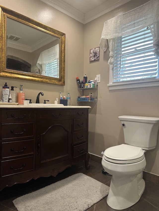 bathroom with tile patterned flooring, vanity, toilet, and crown molding