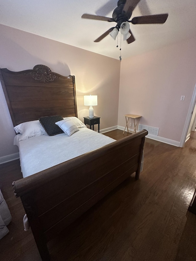 bedroom with ceiling fan and dark wood-type flooring